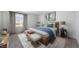 Calm bedroom with a comfortable bed with blue accents and a large window at 3908 N Riviera Ct, Aurora, CO 80019