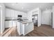 Bright kitchen featuring white cabinets, stainless steel appliances, and a granite-topped island at 3908 N Riviera Ct, Aurora, CO 80019