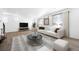 Inviting living room with hardwood floors, white sofa, marble coffee table, and large windows at 3908 N Riviera Ct, Aurora, CO 80019
