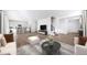 Open-concept layout showcasing living room flowing into the kitchen, featuring hardwood floors at 3908 N Riviera Ct, Aurora, CO 80019