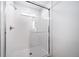 Modern walk-in shower featuring clear glass enclosure and white tile surround at 3908 N Riviera Ct, Aurora, CO 80019