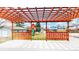 A wooden pergola offers shade to a backyard, with a play set and lawn visible beyond the structure's frame at 3387 S Pitkin Way, Aurora, CO 80013