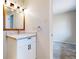 Bathroom features a bright vanity with marble countertop and modern lighting at 3387 S Pitkin Way, Aurora, CO 80013