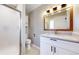 Bathroom with walk-in shower, white vanity, marble counter, and modern lighting at 3387 S Pitkin Way, Aurora, CO 80013