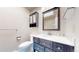 Bright bathroom featuring a vanity and mirror, complete with tile accents at 3387 S Pitkin Way, Aurora, CO 80013