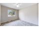 Bedroom features neutral carpet, bright window, and ceiling fan at 3387 S Pitkin Way, Aurora, CO 80013