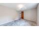 Bedroom featuring neutral walls and carpet, with a view into the doorway at 3387 S Pitkin Way, Aurora, CO 80013