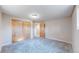 Bedroom with carpeting and sliding closet doors and view into an adjacent room at 3387 S Pitkin Way, Aurora, CO 80013