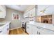 Bright, updated kitchen featuring quartz countertops, stainless steel appliances and a view to a cozy fireplace at 3387 S Pitkin Way, Aurora, CO 80013