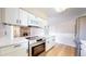 Modern kitchen featuring white cabinets, stainless steel appliances, and quartz countertops at 3387 S Pitkin Way, Aurora, CO 80013