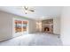 Comfortable living room featuring carpet, fireplace, and a sliding glass door to the backyard at 3387 S Pitkin Way, Aurora, CO 80013