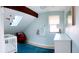 Bedroom features a skylight, sloped ceilings, and a red upholstered chair next to the crib at 3209 Redstone Rd # 12B, Boulder, CO 80305