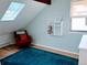 Bedroom features a skylight, red upholstered chair, and unique wall-mounted shelving at 3209 Redstone Rd # 12B, Boulder, CO 80305