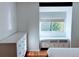 Bright bedroom featuring white dresser, natural light from window, and warm wood flooring at 3209 Redstone Rd # 12B, Boulder, CO 80305