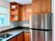Efficient kitchen with stainless steel refrigerator, wood cabinets, stone countertops, and lots of natural light at 3209 Redstone Rd # 12B, Boulder, CO 80305