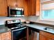 Well-lit kitchen featuring stainless steel appliances, modern cabinets, stone countertops, and subway tile backsplash at 3209 Redstone Rd # 12B, Boulder, CO 80305