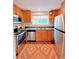Bright kitchen featuring stainless steel appliances, wood cabinets, a stone countertop, and a colorful rug at 3209 Redstone Rd # 12B, Boulder, CO 80305
