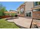 Outdoor patio area with stone floor and backyard featuring lush green lawn and blue sky at 4520 Maroon Cir, Broomfield, CO 80023