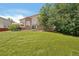 Lush backyard with patio, lawn, and mature trees for outdoor relaxation at 4520 Maroon Cir, Broomfield, CO 80023