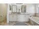 Bathroom featuring double sinks, white cabinetry, and tasteful décor at 4520 Maroon Cir, Broomfield, CO 80023