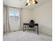 Bedroom with modern desk, chair, and a large window at 4520 Maroon Cir, Broomfield, CO 80023