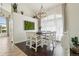 Bright dining area featuring a rustic chandelier, a large window with sheer curtains, and stylish decor, creating an inviting space at 4520 Maroon Cir, Broomfield, CO 80023