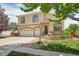 Elegant two-story home with a three-car garage, stone accents, and well-manicured landscaping at 4520 Maroon Cir, Broomfield, CO 80023