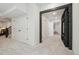 Bright hallway featuring fresh white walls, plush carpet, and black beam entryway at 4520 Maroon Cir, Broomfield, CO 80023