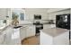Bright kitchen features white cabinets, stainless steel appliances, granite countertops, and a center island for style and functionality at 4520 Maroon Cir, Broomfield, CO 80023