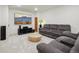 Comfortable living room features plush gray seating, media center, and neutral decor at 4520 Maroon Cir, Broomfield, CO 80023