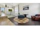 Bright living area featuring modern decor, stylish furniture, and an open view to the dining area, creating an inviting space at 4520 Maroon Cir, Broomfield, CO 80023