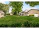 Large backyard with mature trees, landscaping, and multiple outbuildings at 3502 Birch Ave, Parker, CO 80134