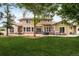 Expansive backyard with a patio, outdoor seating, and a lush green lawn at 3502 Birch Ave, Parker, CO 80134