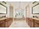 Bathroom featuring double vanities, bathtub and walk-in shower at 3502 Birch Ave, Parker, CO 80134