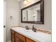 Bathroom featuring a single sink vanity with mosaic tile backsplash and a large mirror at 3502 Birch Ave, Parker, CO 80134