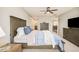 Bedroom with carpet flooring, ceiling fan, ensuite bathroom, and walk-in closet at 3502 Birch Ave, Parker, CO 80134