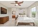 Bright bedroom featuring an ensuite bath, ceiling fan, and view from the windows at 3502 Birch Ave, Parker, CO 80134