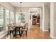 Stylish dining area with wood table, modern chandelier, and views into the cozy living room at 3502 Birch Ave, Parker, CO 80134