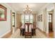 Formal dining room with wooden table, chandelier, and plantation shutters is perfect for entertaining at 3502 Birch Ave, Parker, CO 80134