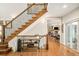 Staircase with wooden steps and iron railing leads from foyer, showcasing home's open layout at 3502 Birch Ave, Parker, CO 80134