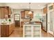Well-appointed kitchen featuring custom wood cabinets, granite countertops and a center island cooktop at 3502 Birch Ave, Parker, CO 80134