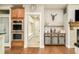 Kitchen showing stainless steel double ovens and a view of the mudroom and adjacent entertaining area at 3502 Birch Ave, Parker, CO 80134