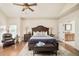 Spacious main bedroom with a ceiling fan, wooden furniture, and a view into the bathroom at 3502 Birch Ave, Parker, CO 80134