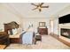Spacious main bedroom with a vaulted ceiling, fireplace, wooden furniture, and a view into the bathroom at 3502 Birch Ave, Parker, CO 80134