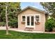 Charming outbuilding featuring white trim, flower boxes and a well-manicured lawn at 3502 Birch Ave, Parker, CO 80134