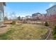 Large backyard features a spacious lawn, wooden fence, and a deck with stairs at 5531 Fox Meadow Ave, Highlands Ranch, CO 80130