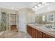 Bathroom featuring double sinks, walk-in shower, and a door to a large walk-in closet at 5531 Fox Meadow Ave, Highlands Ranch, CO 80130
