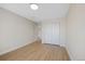 Bright bedroom features wood-look floors, closet, and neutral paint at 5531 Fox Meadow Ave, Highlands Ranch, CO 80130