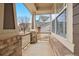 A charming front porch featuring brick columns and a view of the neighborhood at 5531 Fox Meadow Ave, Highlands Ranch, CO 80130