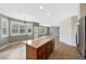 Open kitchen with eat-in space, island, stainless steel refrigerator, wood cabinets, and large windows at 5531 Fox Meadow Ave, Highlands Ranch, CO 80130